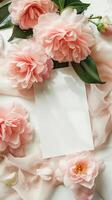 A white table with a bunch of pink camellias on the table photo