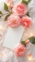 A white table with a bunch of pink camellias on the table photo