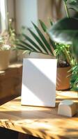 a5 white card standing ontop of a desk, product image photo