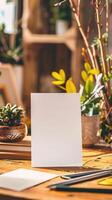 a5 white card standing ontop of a desk, product image photo