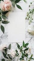 aerial photograph Flatlay style with blank art paper, atop clean marble white table top and fresh flowers placed around the display, photo
