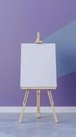 An easel with a white canvas on a stretcher stands in a clean purple blue room photo