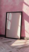 an empty frame on the floor in front of a pink wall photo