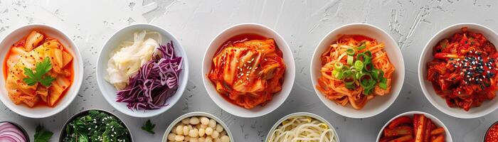 kimchi feast, featuring several types of kimchi laid out on a stark white table, broad space on the left for promotional text. photo