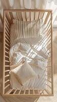 baby crib with white blank bedded bedding from above, charming perspective mockup, charming childish style boho photo