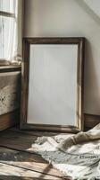 closeup image of an empty framed poster leaning against a wall on a wooden floor photo