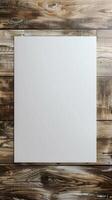 mockup, a white sheet of white poster in a corner on a wooden table photo