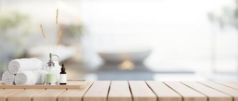 A toiletry set with an empty space on a wooden plank tabletop in a modern luxury bathroom. photo