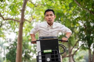 An anxious Asian businessman is in a hurry to get to work in the morning, riding a bike. photo