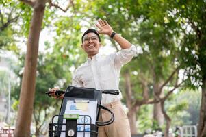 A happy businessman smiles and waves while pushing his bike, greeting someone while heading to work. photo