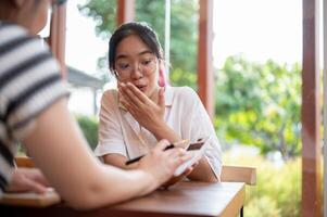 An amazed young Asian woman surprised with the numeric on a calculator. photo