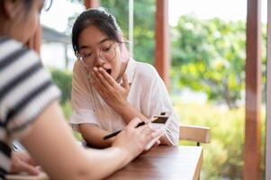 An amazed young Asian woman surprised with the numeric on a calculator. photo