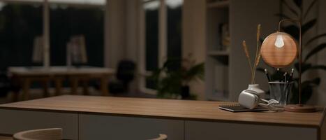 A modern home office at night with a space to display your product on a minimal wooden table. photo