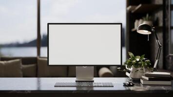 Modern home office workspace with a white-screen computer and decor on a modern black marble table. photo