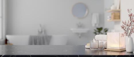 A copy space on a black marble countertop with toiletries in a modern white and clean bathroom. photo