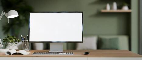 A home office workspace with a computer mockup on a desk in a modern living room with green color. photo