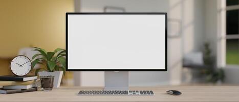 A computer mockup with decor on a minimal wood table in a modern office room. photo