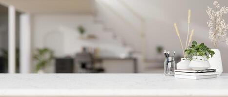 Accessories and empty space on a white tabletop with a blurred background of a modern home office. photo