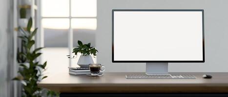 A computer desk in a minimal white room features a white-screen computer mockup on the desk. photo