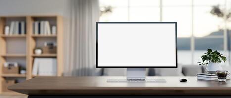 A white-screen computer mockup on a wooden desk in a contemporary living room. photo