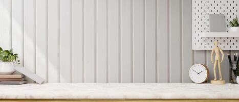 A display space on a white tabletop features decor objects against the white wall. photo