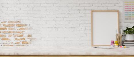 A white tabletop features painting tools and display space against the white brick wall. photo