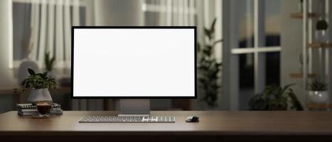 A computer desk in a contemporary minimalist room in the evening features a computer mockup. photo