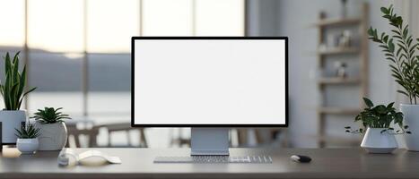 A computer desk in a modern co-working space feature a white-screen computer mockup. photo