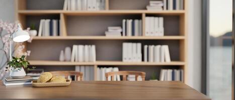 A wooden long table feature a space for display products against a large bookshelf in the background photo