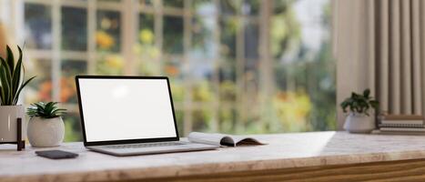 Home office workspace, a white-screen laptop computer mockup on a table in a comfortable room. photo