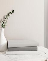 Products pedestal on books on a luxury white marble table feature a minimal flower vase. photo