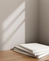 Books on a wooden table against the grey wall with daylight shadow. Pedestal for showcasing products photo