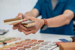 A close-up image of an interior designer handing the color and material samples for the interior. photo