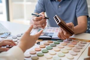 A close-up image of an expert interior designer or architect having a meeting with his client. photo