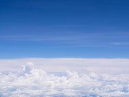 Aerial view of cloudscape seen through airplane window photo