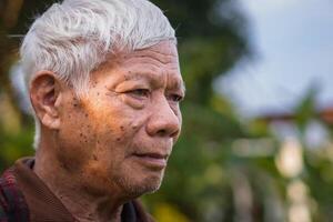 Close-up of face elderly man smiling. Space for text. Concept of aged people and healthcare photo