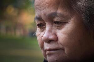 Close-up of face senior woman smiling and looking away. Concept of aged people and healthcare photo