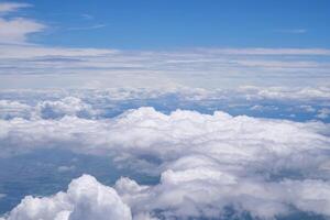 Aerial view of clouds and sky seen through the airplane window photo