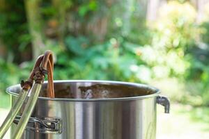 A copper immersion heat exchanger is used in the craft beer process. Selective focus. Homebrewing process photo