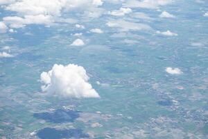 Beautiful view from airplane window above the clouds. Bright blue sky and white clouds. Skyline background with copy space. photo