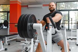 Young handsome man engaged in the gym photo