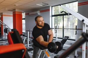 Young handsome man engaged in the gym photo