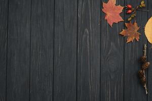 Background texture with old wooden table and yellow autumnal leaves. Autumn maple leaves on wooden background with copy space. Top view. photo