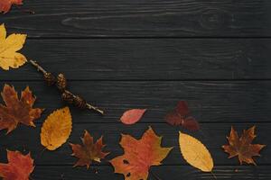 Background texture with old wooden table and yellow autumnal leaves. Autumn maple leaves on wooden background with copy space. Top view. photo