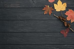 Background texture with old wooden table and yellow autumnal leaves. Autumn maple leaves on wooden background with copy space. Top view. photo