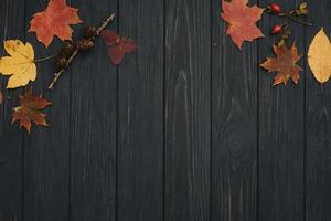 Background texture with old wooden table and yellow autumnal leaves. Autumn maple leaves on wooden background with copy space. Top view. photo