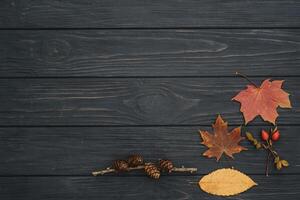 Background texture with old wooden table and yellow autumnal leaves. Autumn maple leaves on wooden background with copy space. Top view. photo