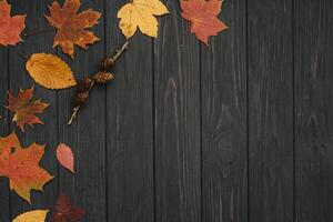 Background texture with old wooden table and yellow autumnal leaves. Autumn maple leaves on wooden background with copy space. Top view. photo