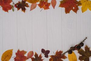 Background texture with old wooden table and yellow autumnal leaves. Autumn maple leaves on wooden background with copy space. Top view. photo