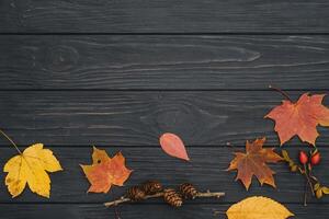 Background texture with old wooden table and yellow autumnal leaves. Autumn maple leaves on wooden background with copy space. Top view. photo